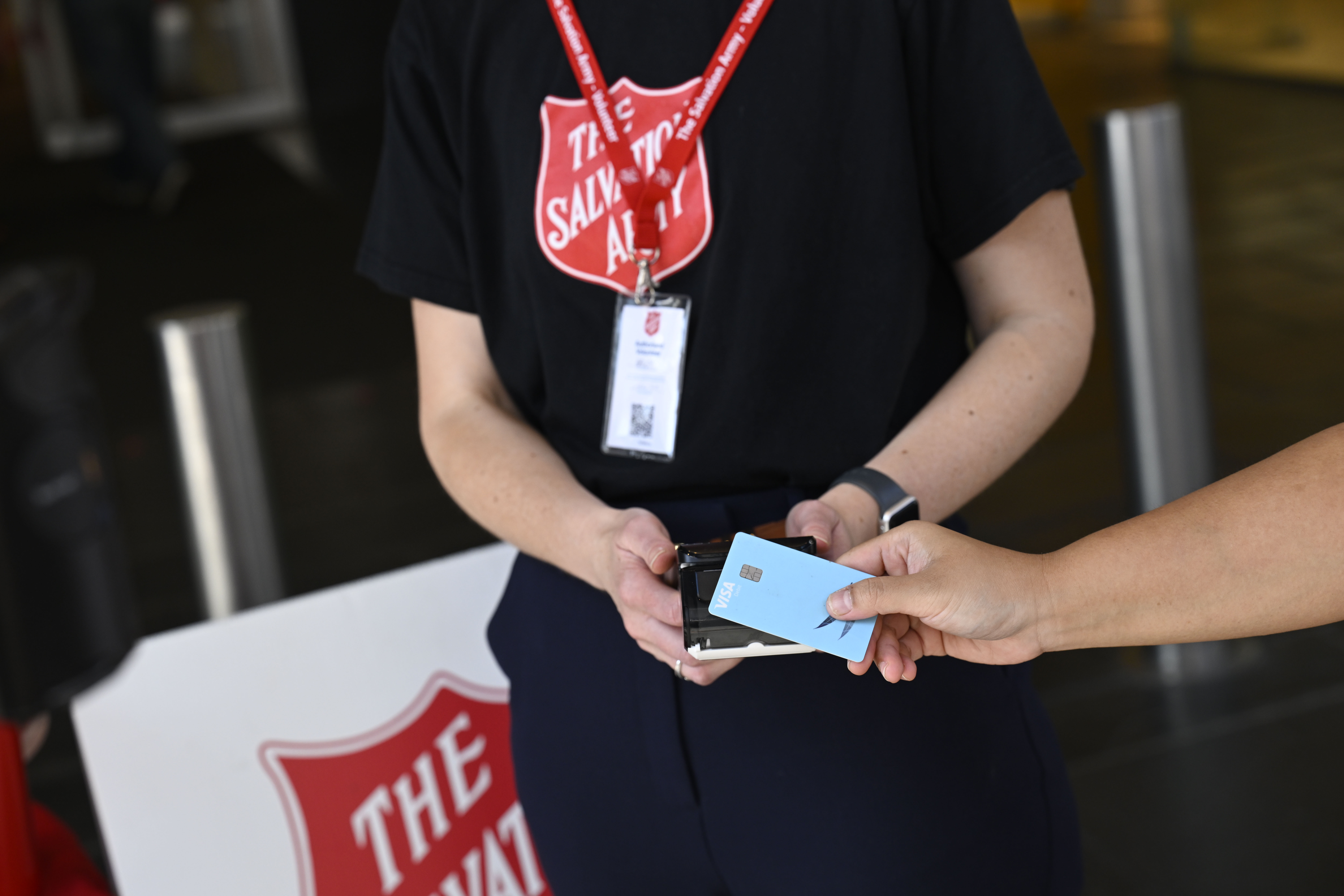 Person making a donation transaction with their phone