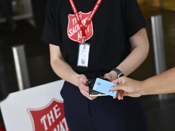 Person making a donation transaction with their phone