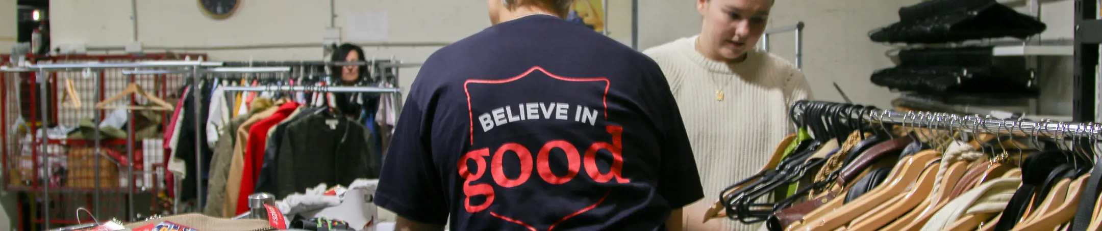 People sorting through clothes at a salvos store