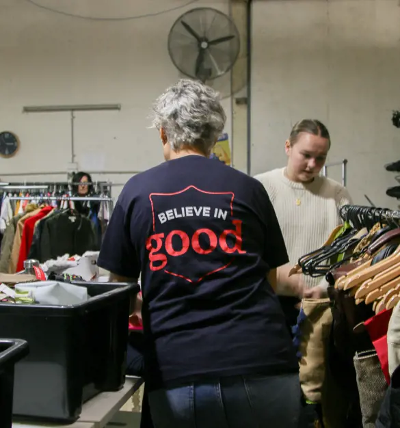 People sorting through clothes at a salvos store