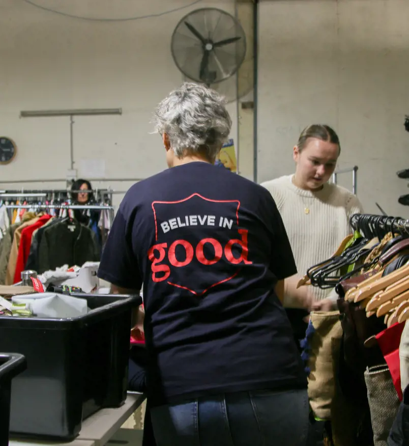 People sorting through clothes at a salvos store