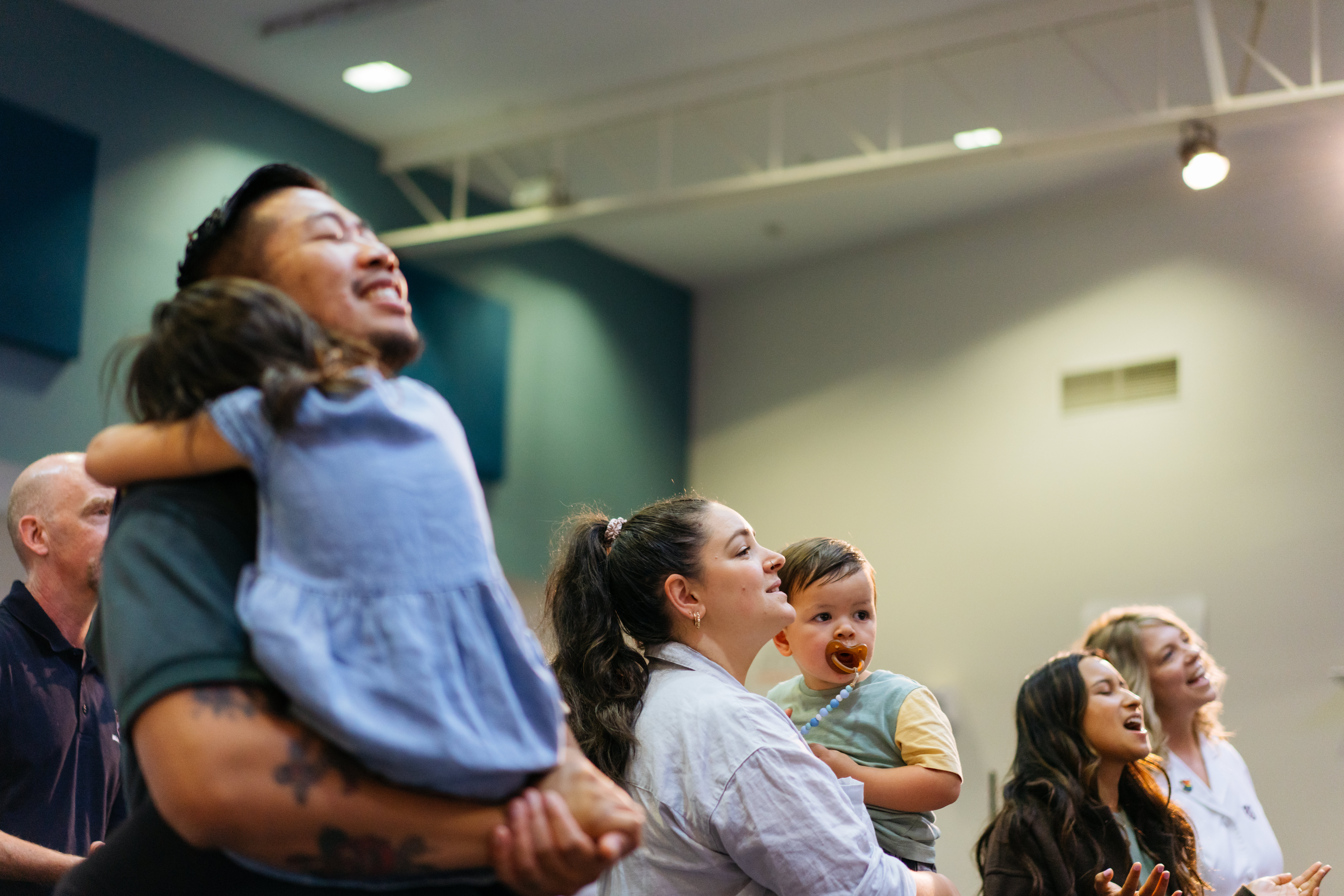 Man holding his child during a church service
