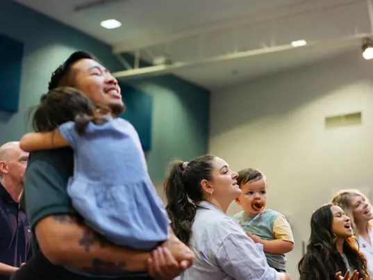 Man holding his child during a church service