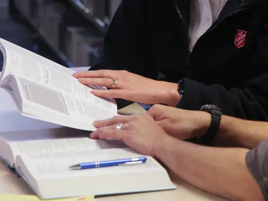 Two people studying with their bibles