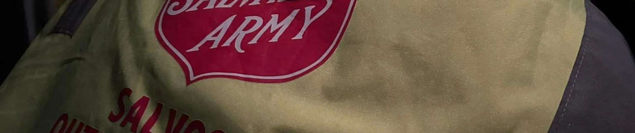 A volunteer with the Salvos at the Bellarine Peninsula - the back of their vest showing.