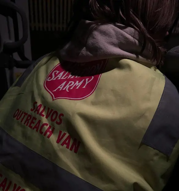 A volunteer with the Salvos at the Bellarine Peninsula - the back of their vest showing.