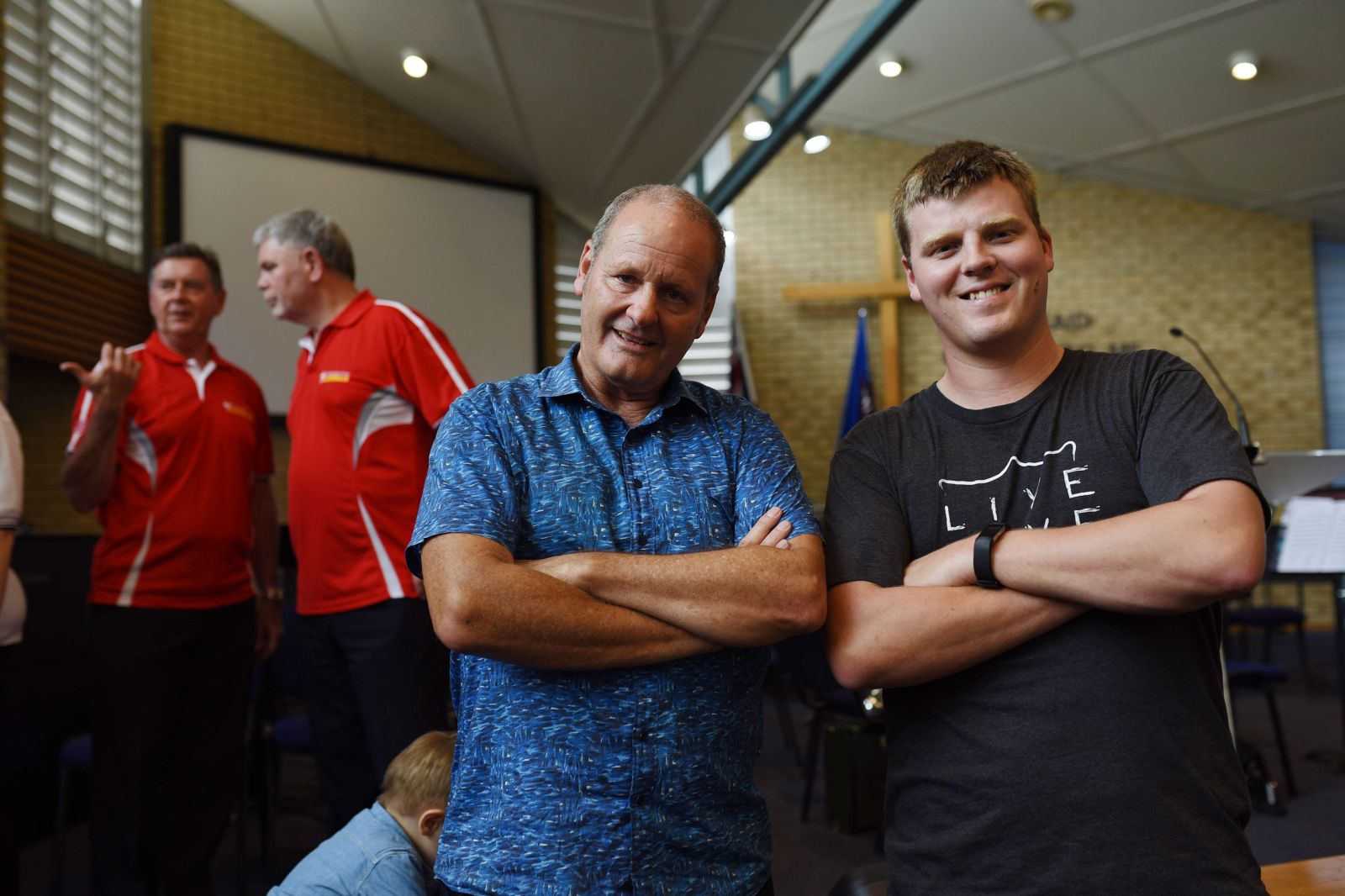 Men smiling at men's event