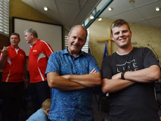 Men smiling at men's event