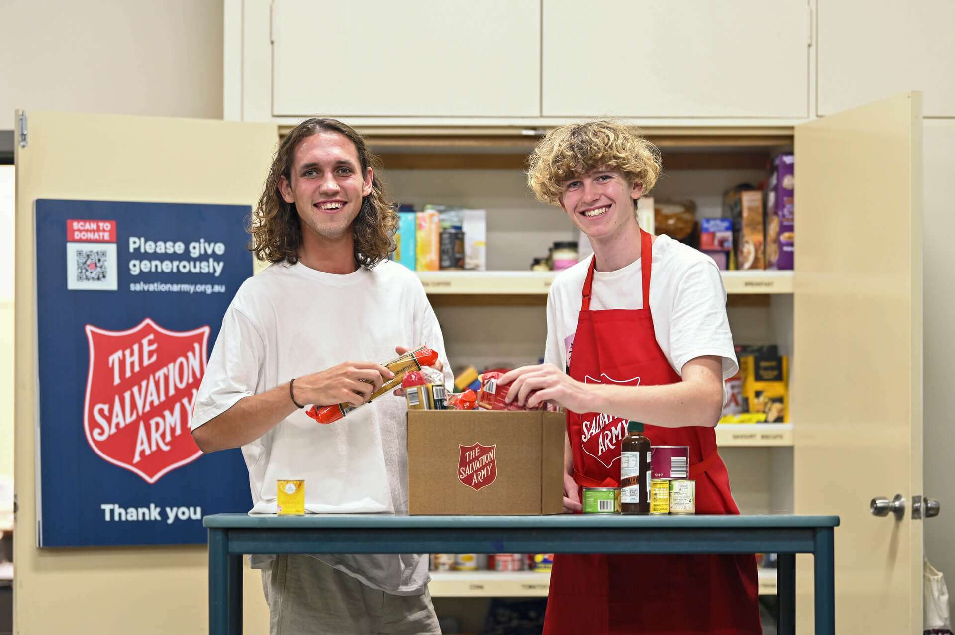 Salvos preparing a food hamper for those in need.