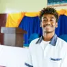 A young man smiles warmly