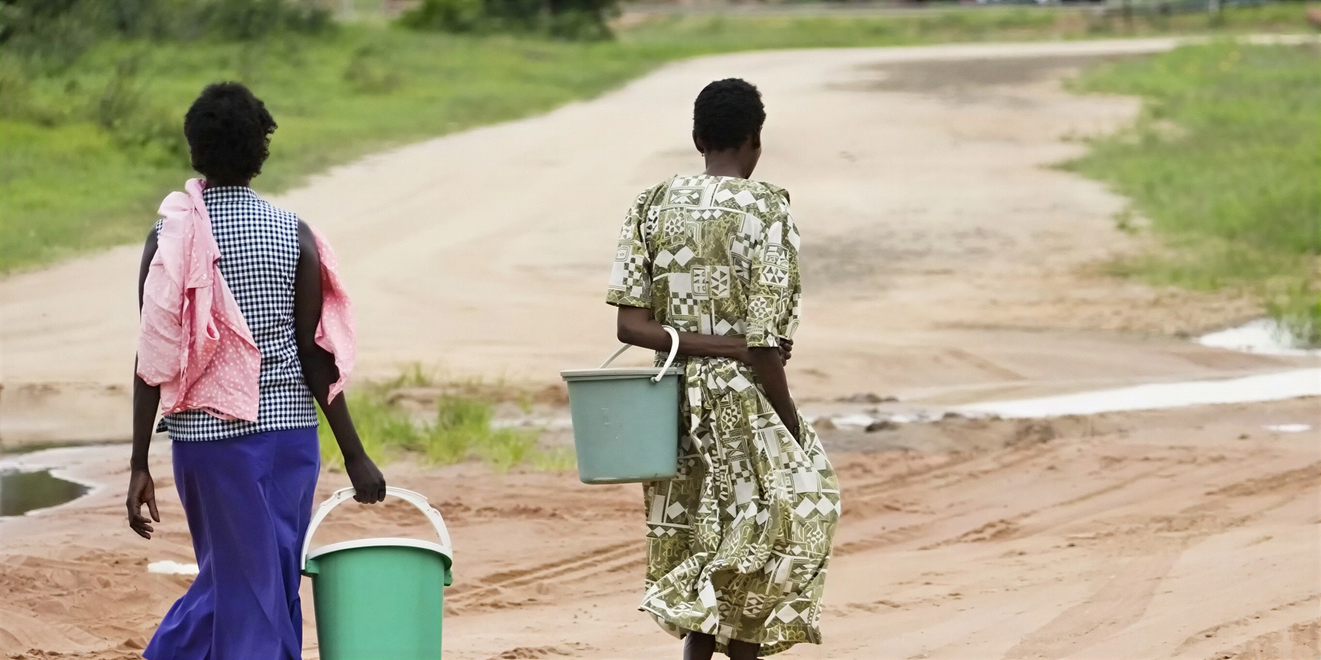 Lillian brings water back to her farm.