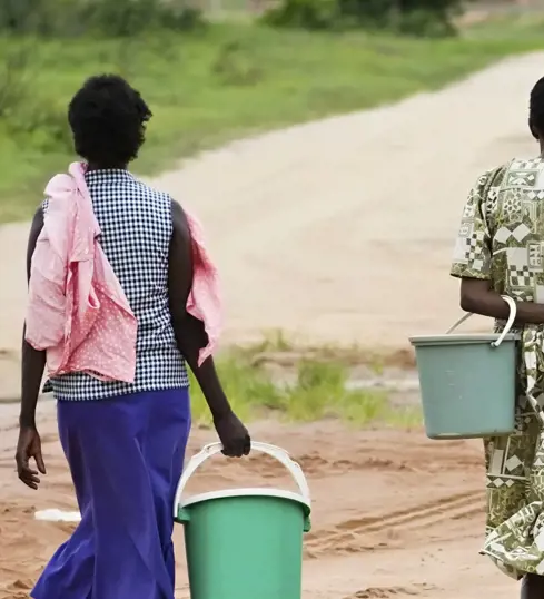Lillian brings water back to her farm.