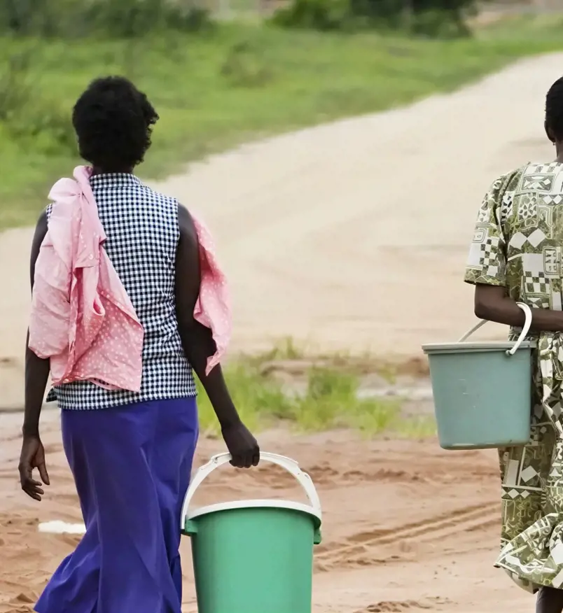 Lillian brings water back to her farm.