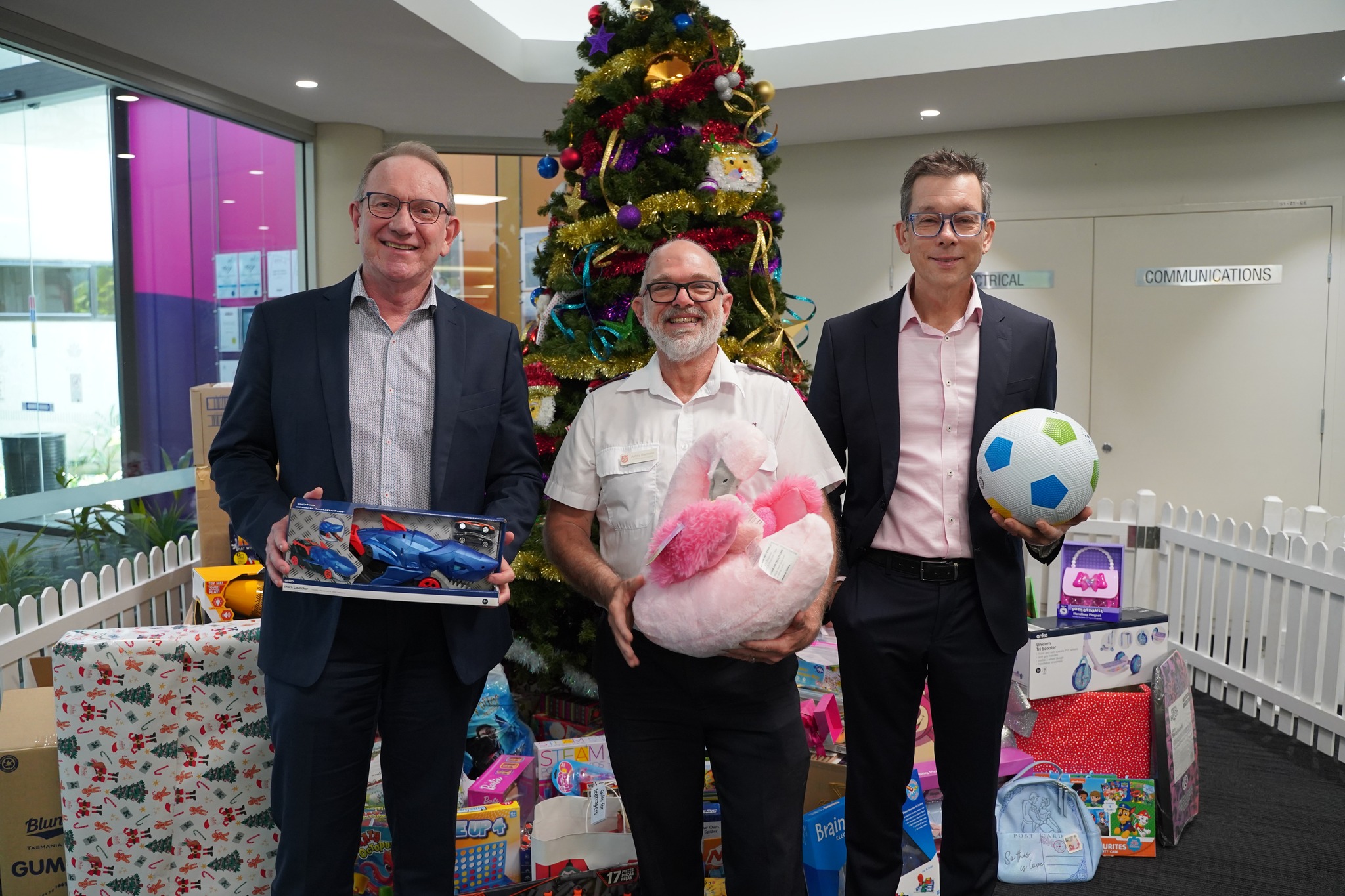 Men at Logan Salvation Army holding Christmas presents