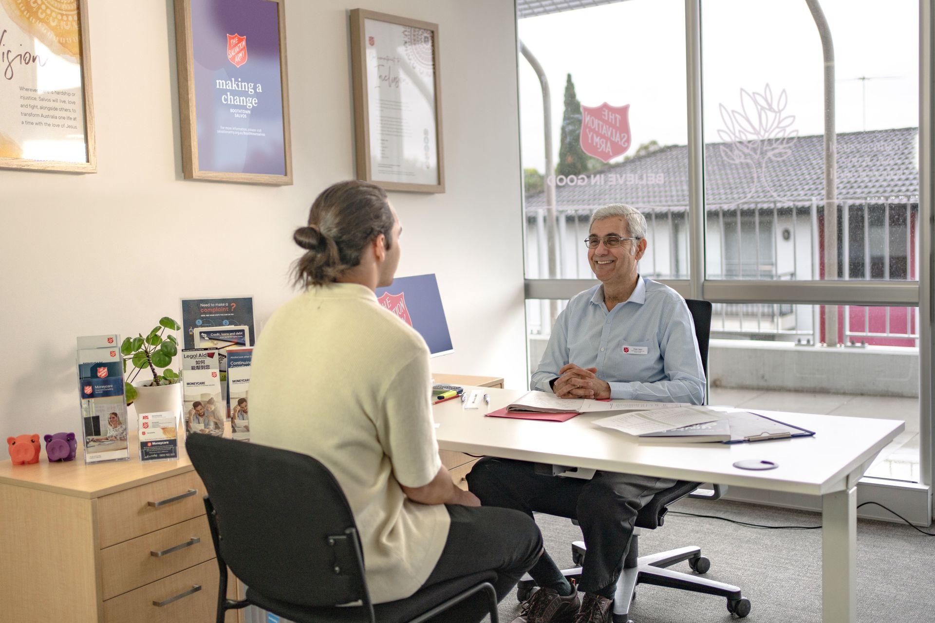 Young man talking to Moneycare Financial Counsellor