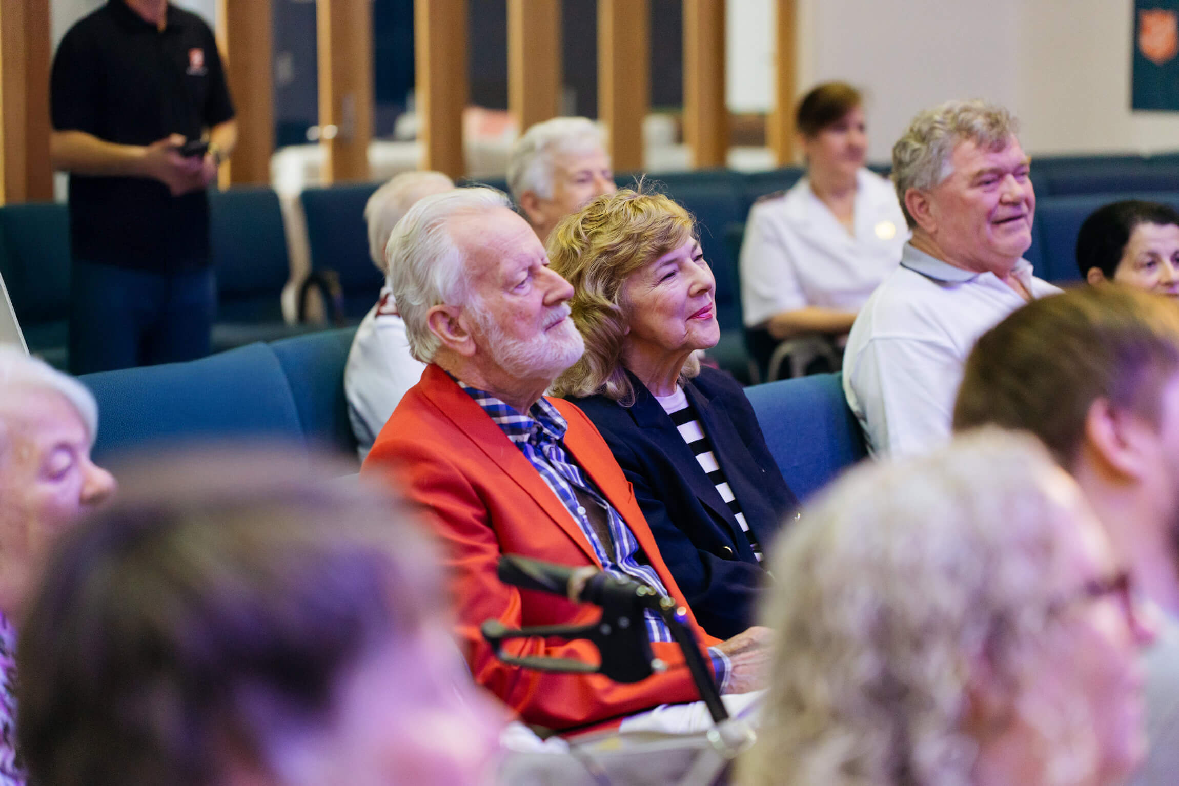 A Salvos crowd of a gathering sitting and watching an event