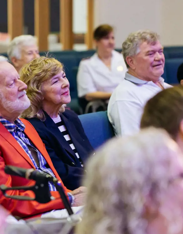 A Salvos crowd of a gathering sitting and watching an event