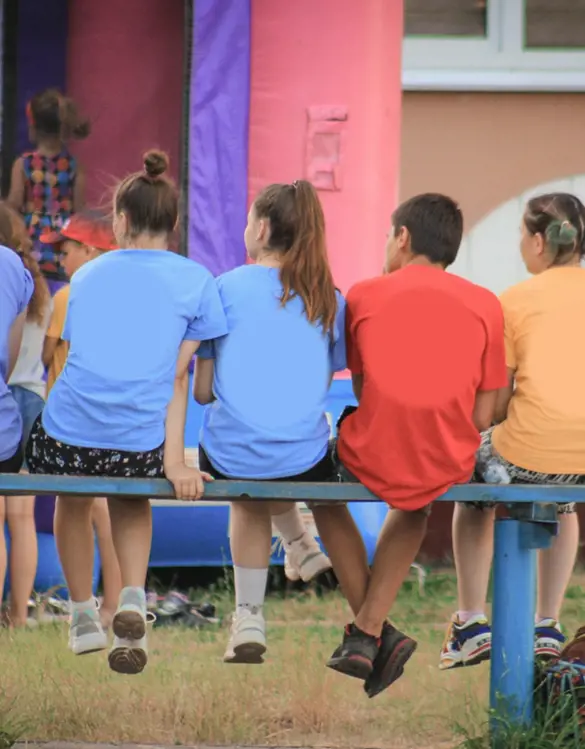 Rear view of a group of teenagers sitting together.
