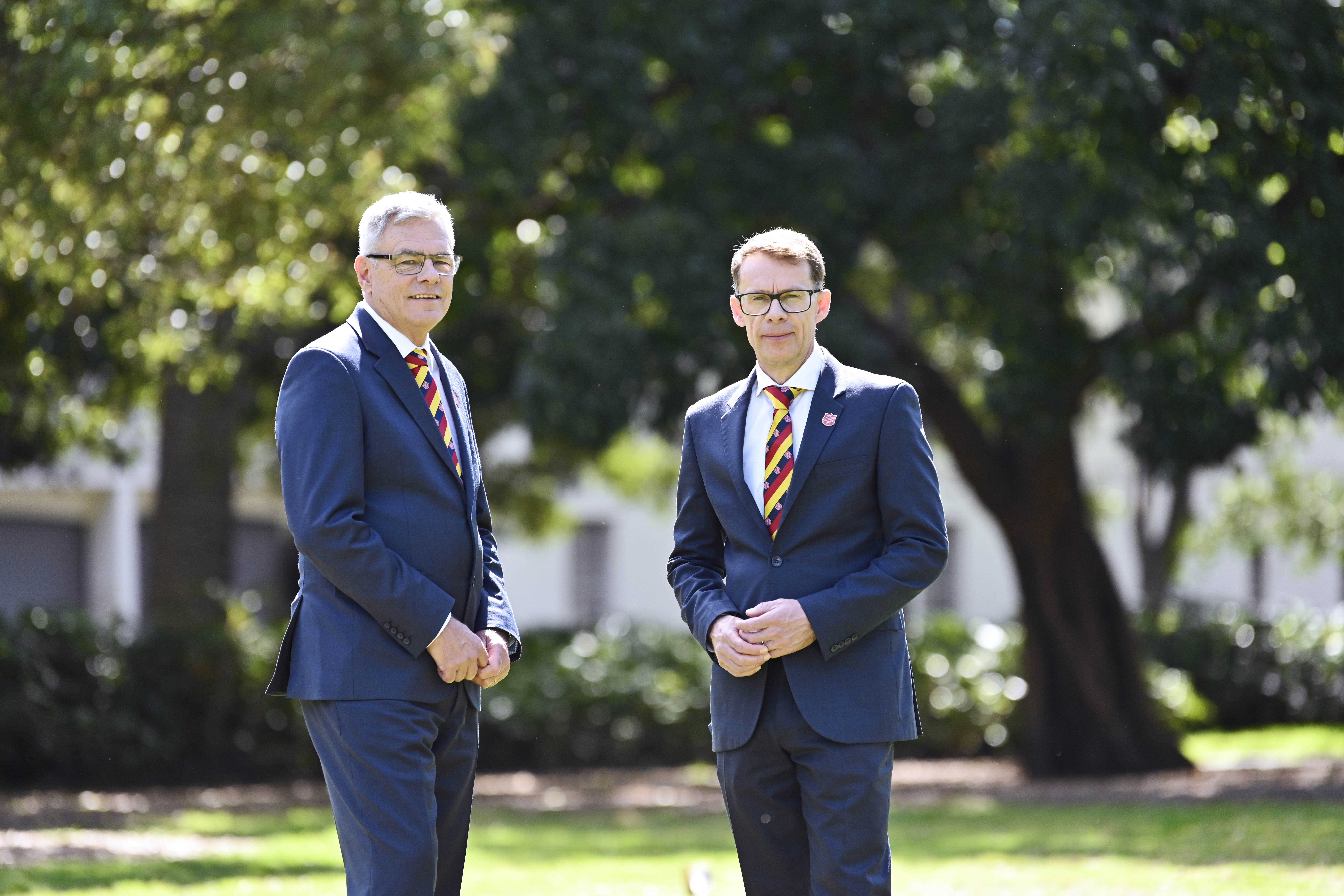 Russell and Malcolm from Salvos Funerals standing together outdoors