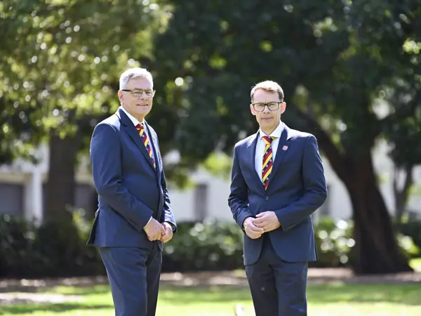 Russell and Malcolm from Salvos Funerals standing together outdoors