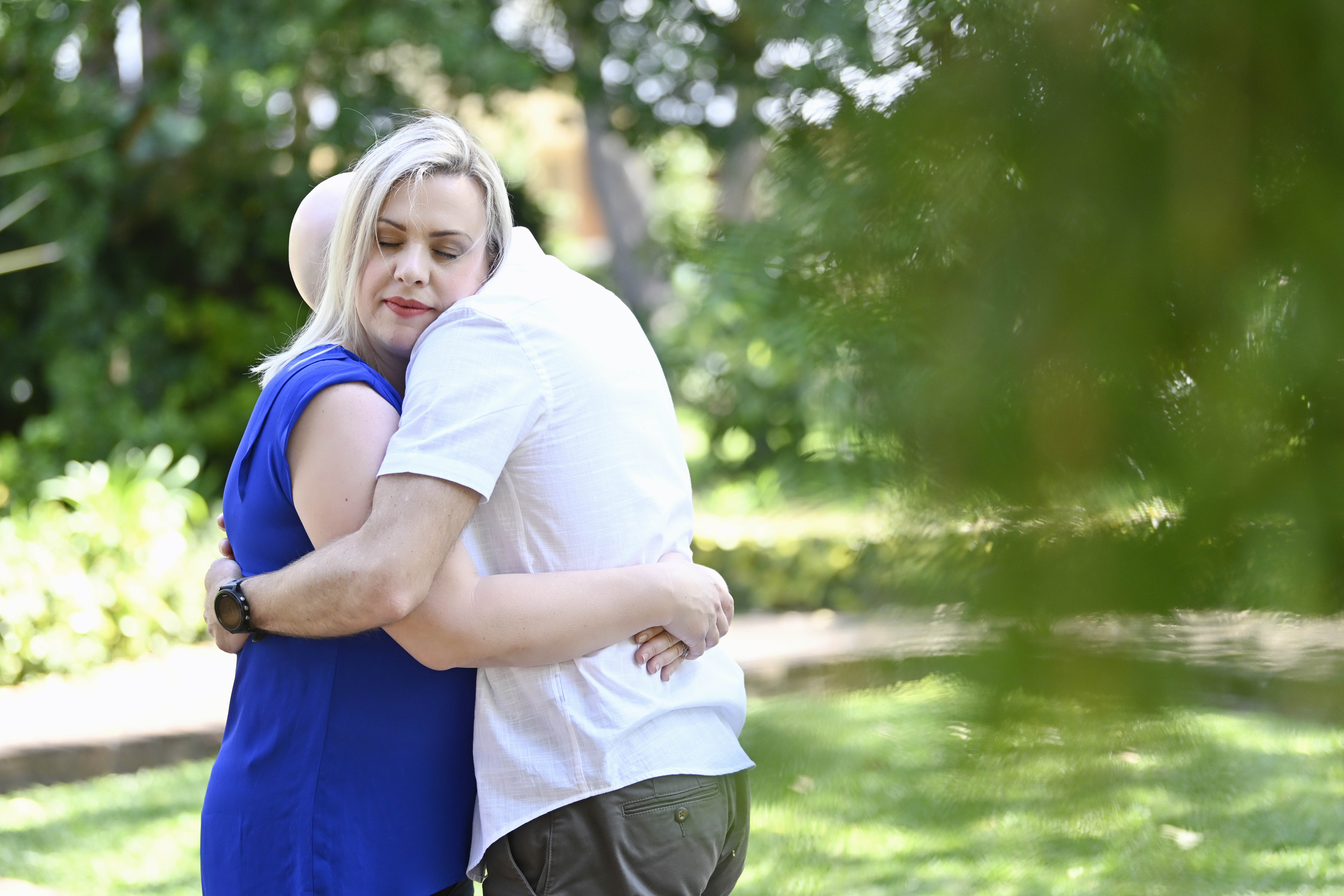 Woman embracing a loved one outdoors