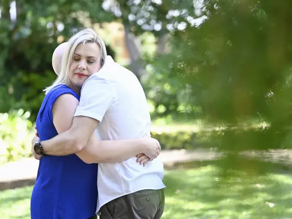 Woman embracing a loved one outdoors