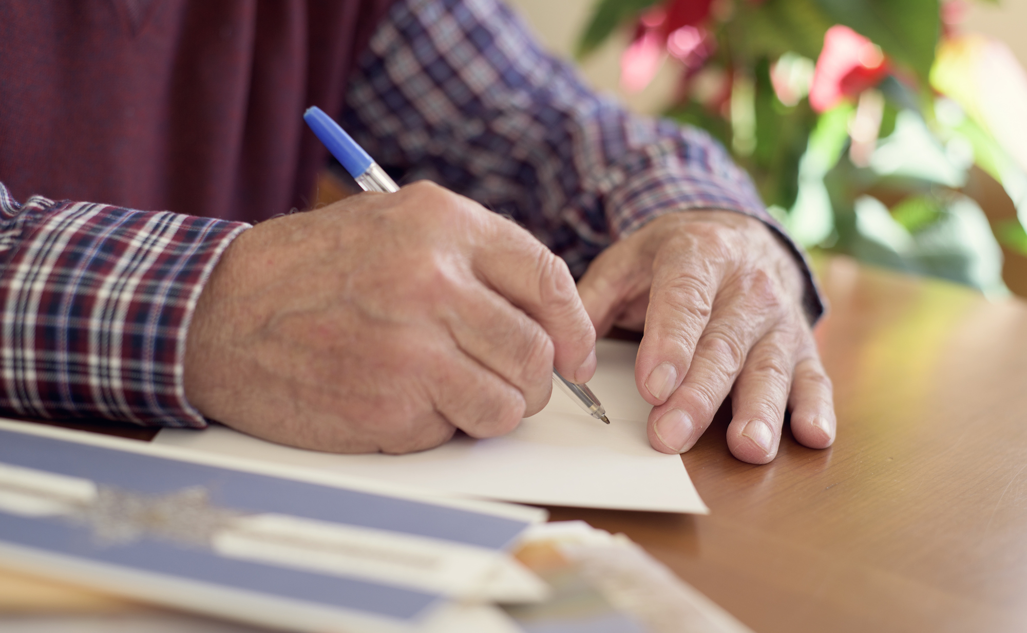 Person writing a sympathy card by hand