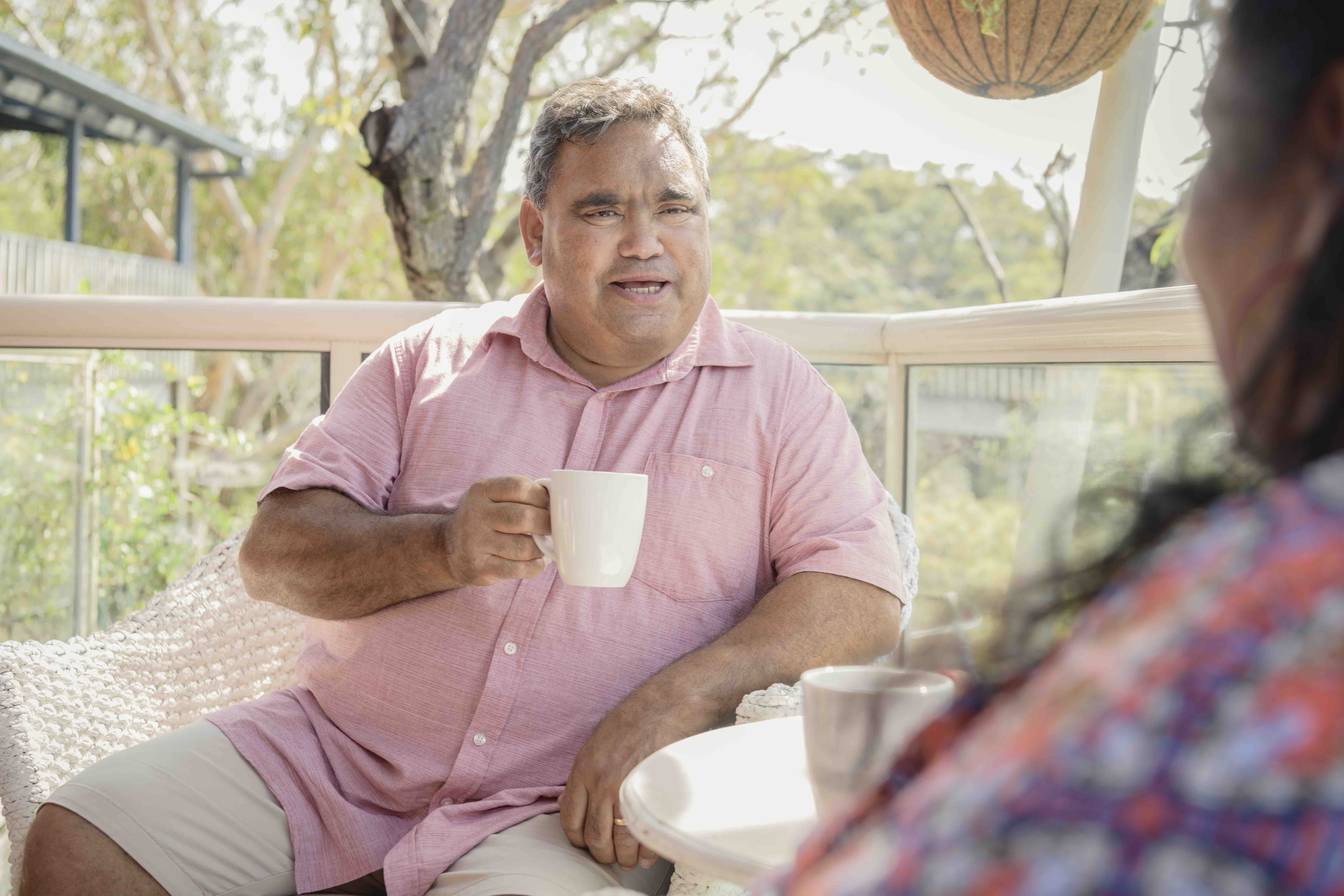 Man having a conversation over a cup of tea