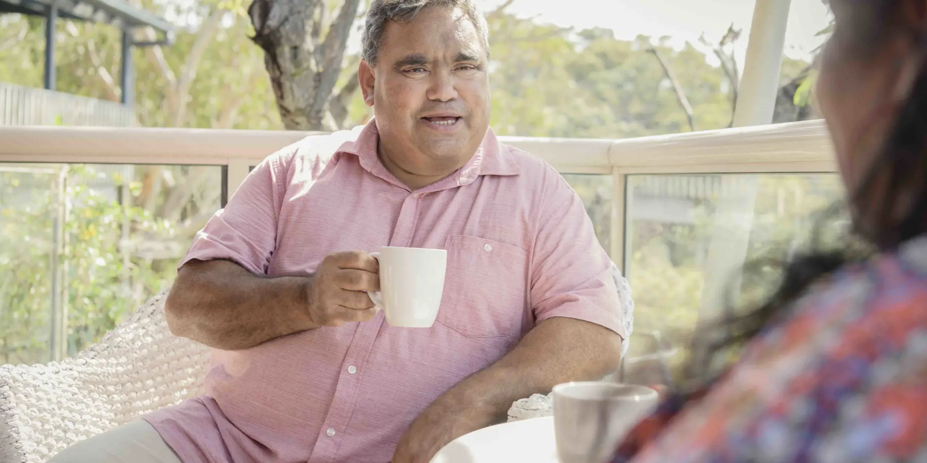 Man having a conversation over a cup of tea